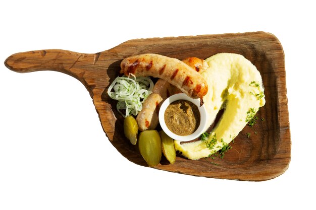 Fried sausage with mashed potatoes on a wooden board