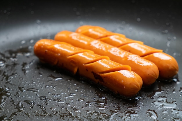 Fried sausages in a pan