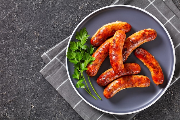 Fried sausages on a plate top view