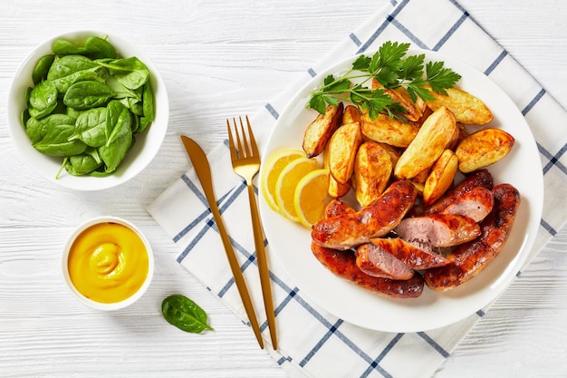 Fried sausages on a plate with potatoes