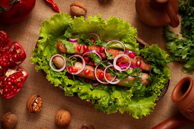 fried sausages , with herbs and spices, top view