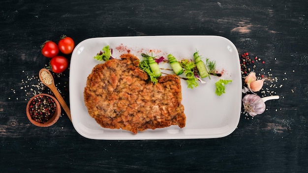 Fried schnitzel from pork Top view On a wooden background Copy space