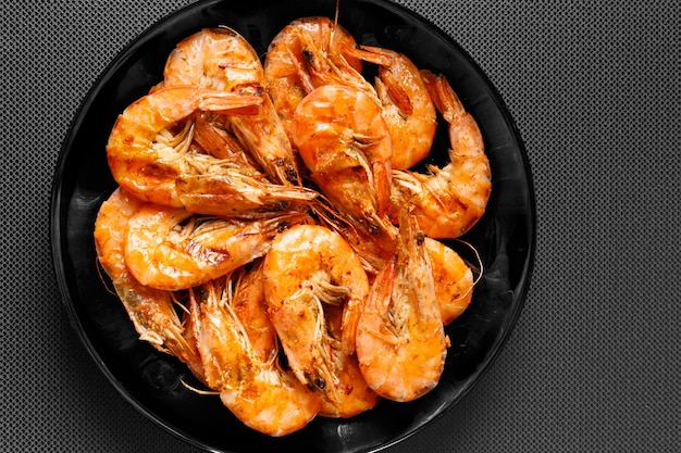 Fried shrimp on a dark background top view