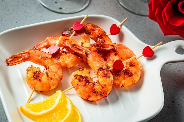 Fried shrimp, roses and champagne close up. Original appetizer for Valentine's Day, romantic dinner. High quality photo