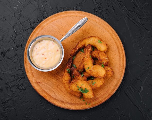 Fried shrimps or prawns with sauce on board