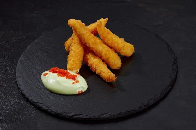 Fried Shrimps tempura with sweet sauce on black board stone