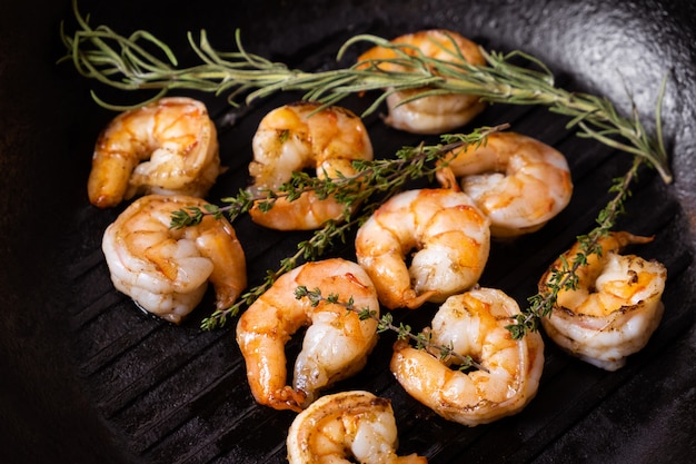 Fried shrimps with herbs, close up view.