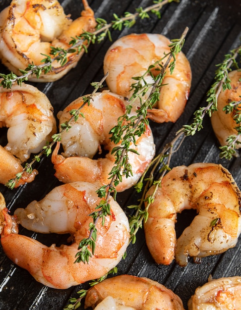 Fried shrimps with herbs, close up view.