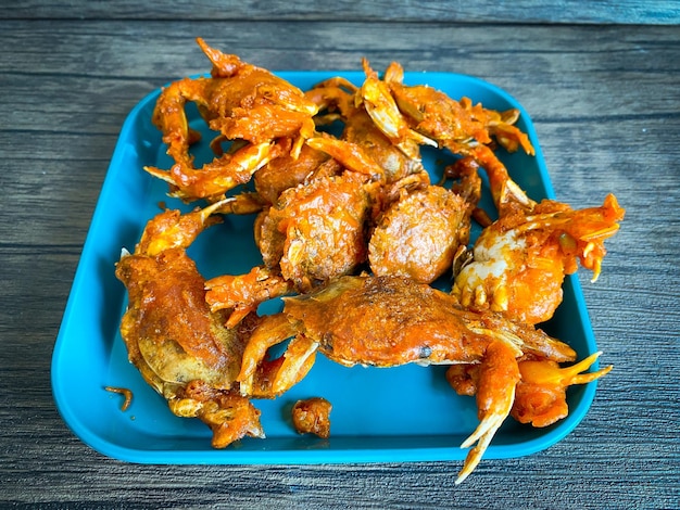 Fried small crab on a wooden table