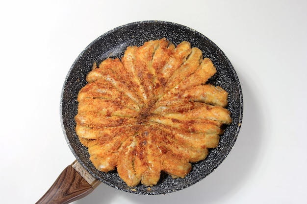 Fried small fish on a metal pan, Hamsa Turkish national cuisine