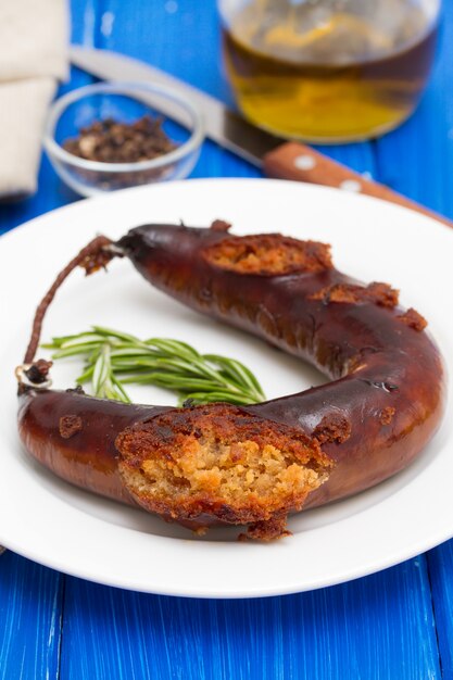 Fried smoked sausage on white plate