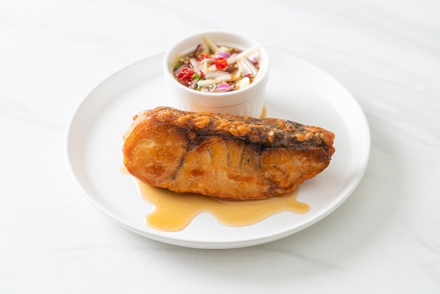 Fried snapper fish with fish sauce and spicy salad