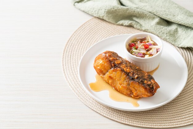 Fried snapper fish with fish sauce and spicy salad