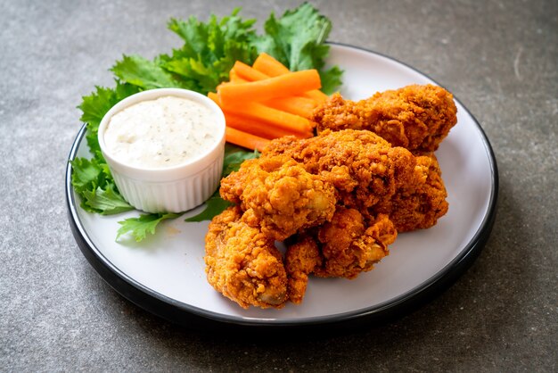 fried spicy chicken wings with vegetable