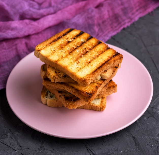 Fried square pieces of white wheat flour in a ceramic plate