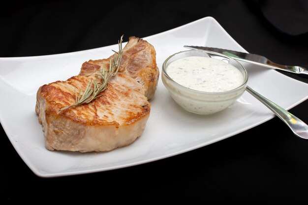 Fried steak with rosemary and white sauce