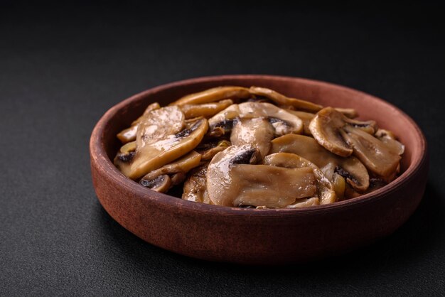 Fried or stewed champignon mushrooms in the form of slices with onions