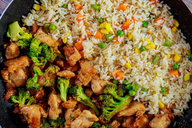 Fried sweet ans sour chicken with steamed rice. Close up.