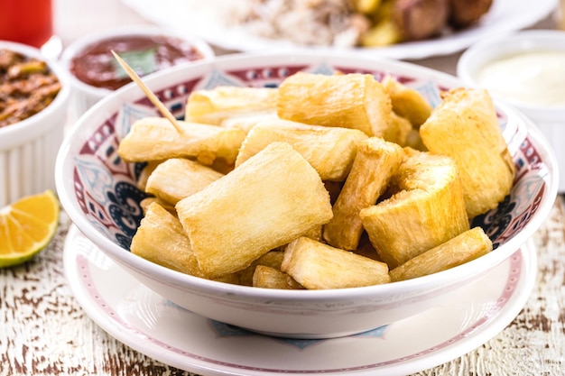 Fried sweet cassava served with vegetables and spices typical Brazilian food