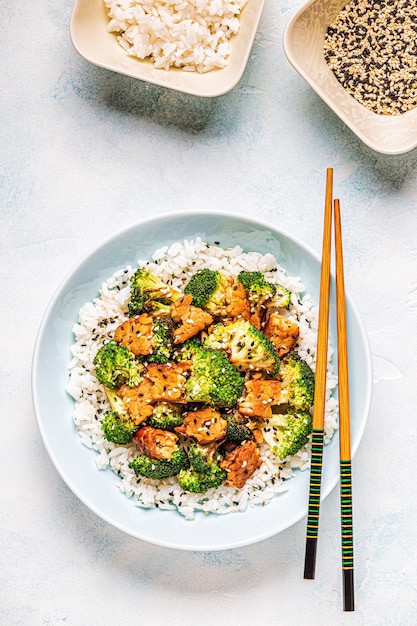 Fried tempeh with rice and broccoli, traditional indonesian cuisine.