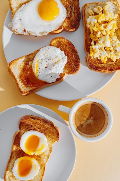 Fried Toast bread with four different types of cooked chicken eggs scrambled eggs fried eggs poached egg and creamed egg Breakfast of chicken eggs