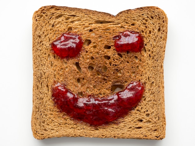 Fried toast with red jam in shape of smile