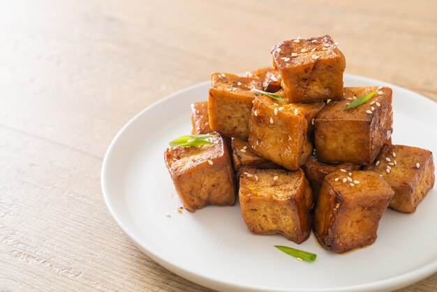 fried tofu with white sesame and teriyaki sauce - vegan and vegetarian food style