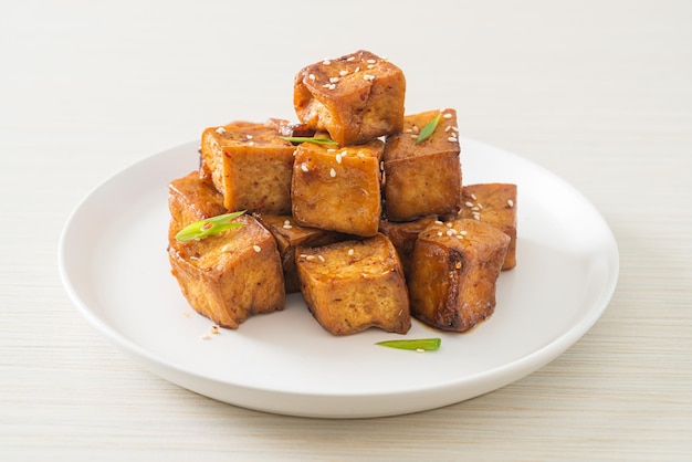 fried tofu with white sesame and teriyaki sauce - vegan and vegetarian food style