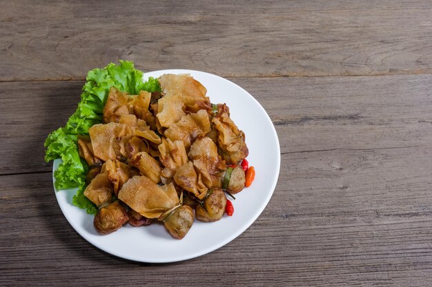 fried wonton or Toong Tong isolated on wood background