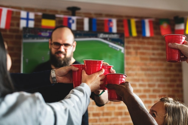 Photo frieds cheering sport at bar together