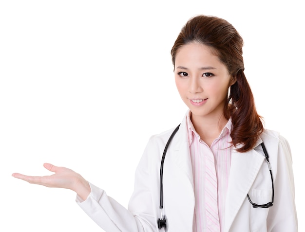 Friendly Asian doctor woman introduce something, closeup portrait isolated on white wall.