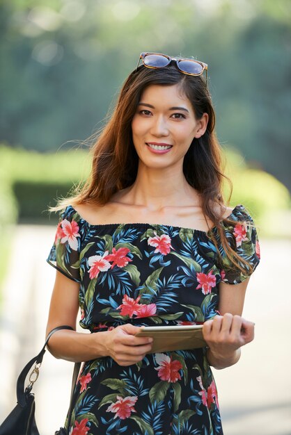 Friendly Asian lady with tablet