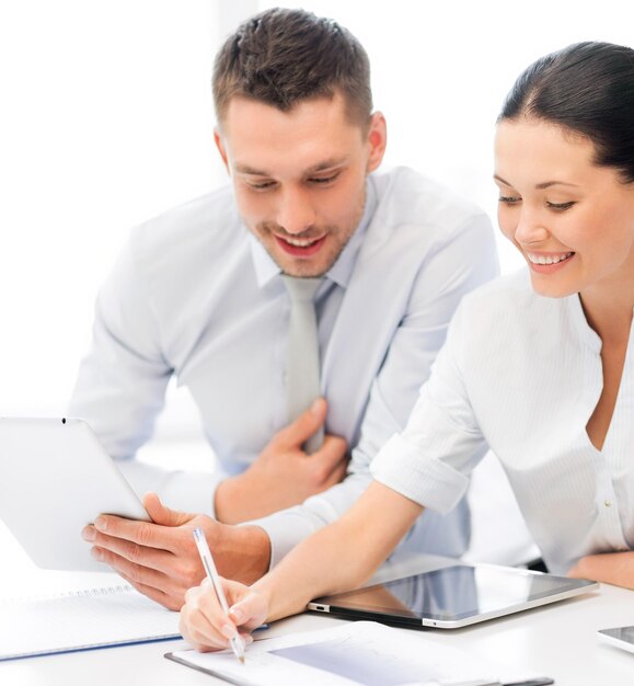 friendly business team with tablet pcs having discussion in office