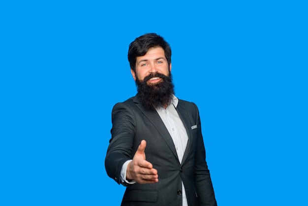 Friendly businessman is welcome handshaking portrait of bearded businessman businessman in suit