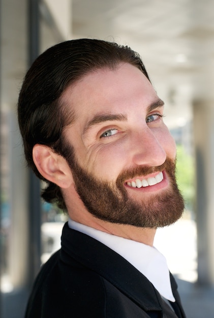 Friendly businessman smiling outdoors