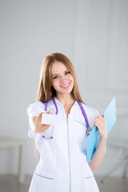 Friendly doctor showing business card sign