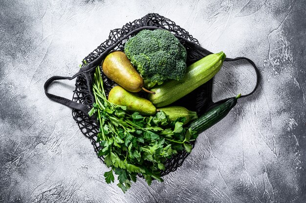 Friendly eco reusable bag of green vegetables.