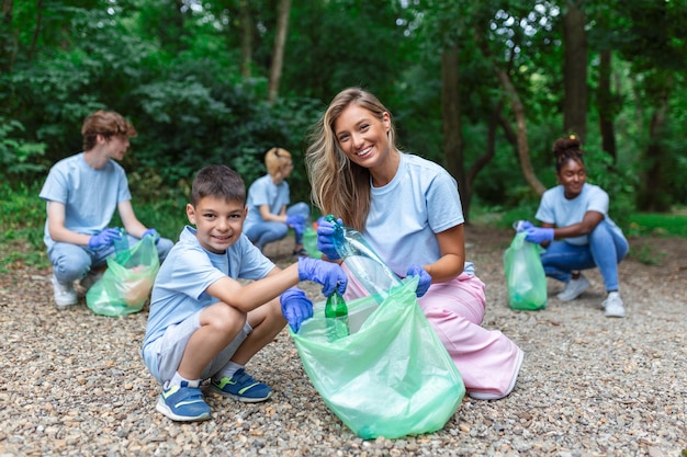 Friendly family and friends organized a cleaning day to clean the park of household garbage People participate in natural cleaning