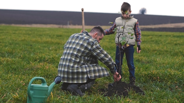 The friendly family planting a tree