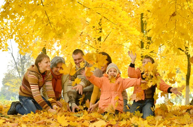 Friendly family on a walk during the fall of the leaves in the park