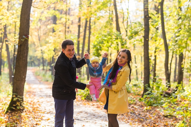 Friendly family walking in the park in autumn together