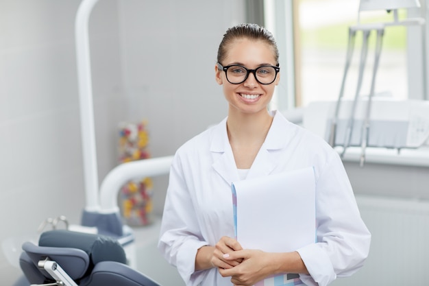 Friendly Female Dentist Posing in Office