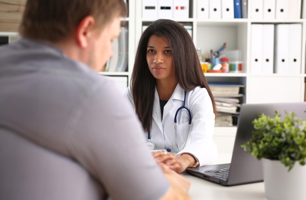 Friendly female doctor hold male patient