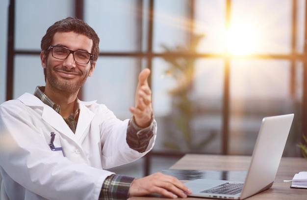 friendly male doctor with open hand ready for hugging