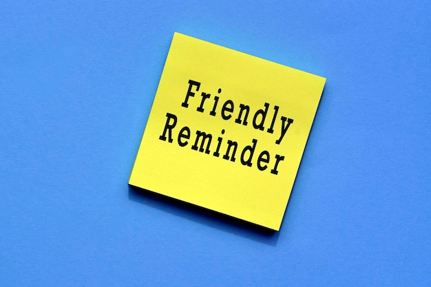 Photo friendly reminder text on yellow sticky note with blue background