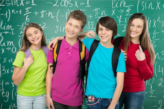 Friendly school children with backpacks concept - isolated on white