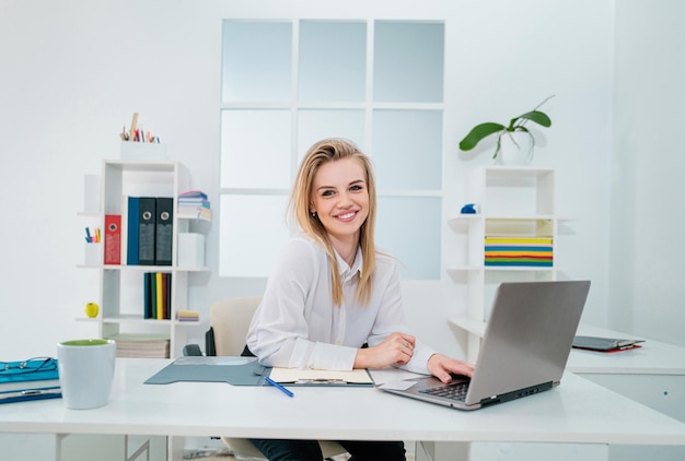 friendly secretary woman behind the reception desk administrator
