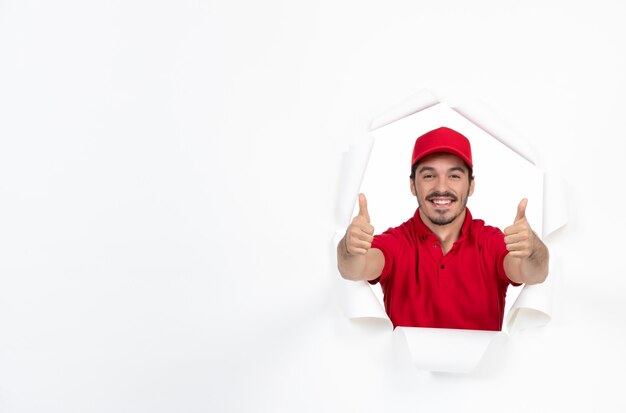 Friendly young courier in red uniform on white