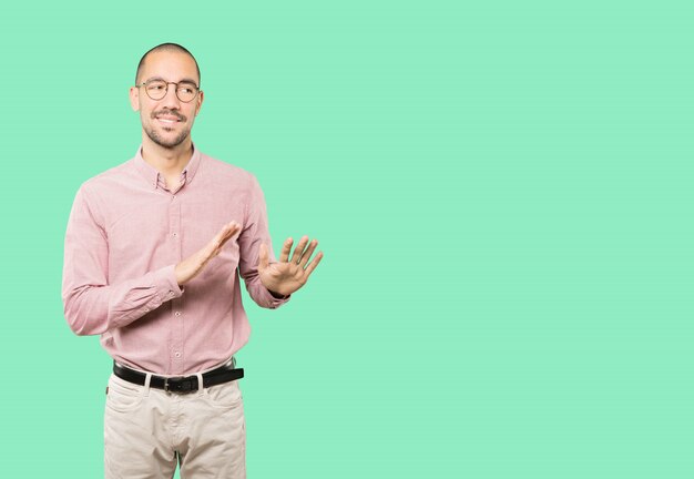 Friendly young man doing a gesture of keep calm