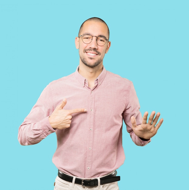 Friendly young man doing a gesture of keep calm